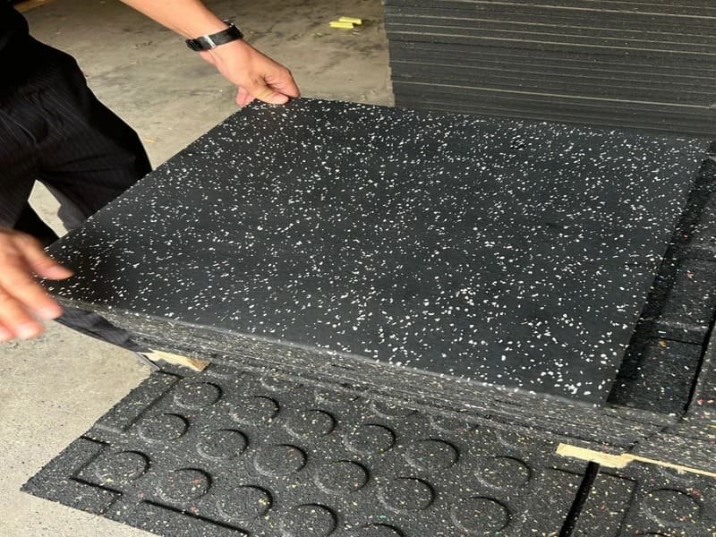 Professional rubber flooring installation showing different layers